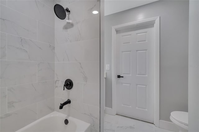 bathroom with toilet, tiled shower / bath combo, and tile patterned floors