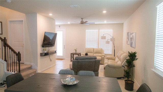 living room featuring light tile patterned floors, baseboards, visible vents, stairs, and recessed lighting