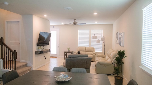 interior space with light tile patterned floors, baseboards, a ceiling fan, stairs, and recessed lighting