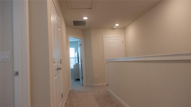 hallway featuring baseboards, recessed lighting, visible vents, and light colored carpet