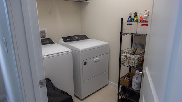 washroom featuring laundry area, light tile patterned floors, and separate washer and dryer