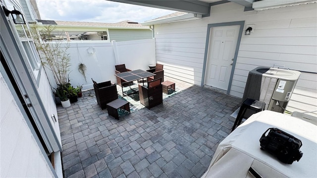 view of patio / terrace featuring fence, central AC, and outdoor dining space