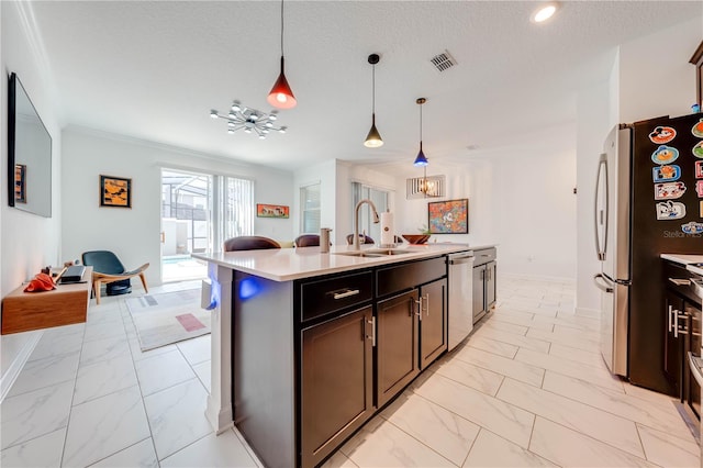 kitchen featuring an island with sink, hanging light fixtures, marble finish floor, light countertops, and a sink