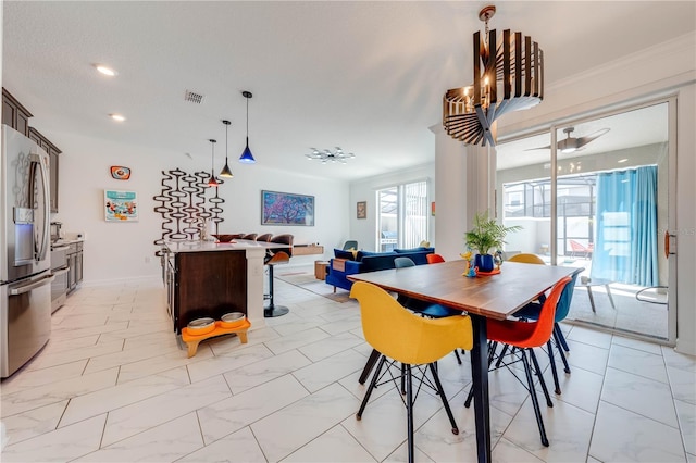 dining space featuring marble finish floor, visible vents, and ornamental molding