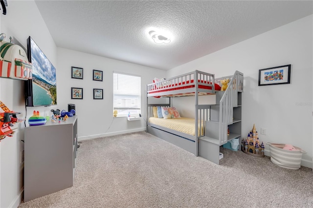 bedroom with carpet floors, a textured ceiling, and baseboards