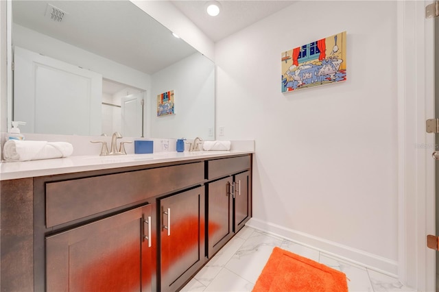 full bathroom with a sink, visible vents, baseboards, marble finish floor, and double vanity