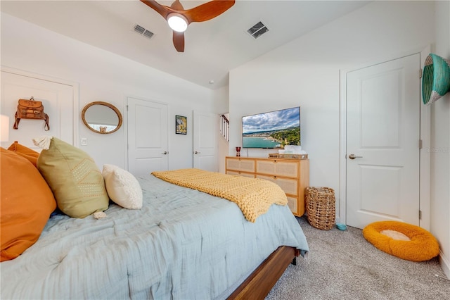 carpeted bedroom featuring lofted ceiling, ceiling fan, and visible vents