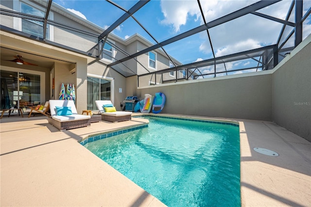 outdoor pool featuring glass enclosure and a patio