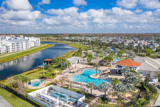 drone / aerial view featuring a residential view and a water view