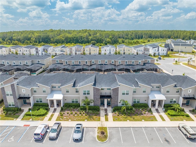 drone / aerial view with a forest view and a residential view