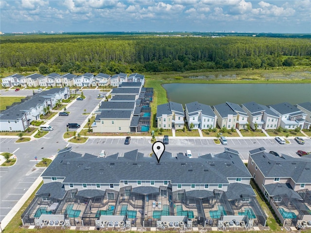 aerial view with a residential view, a water view, and a wooded view