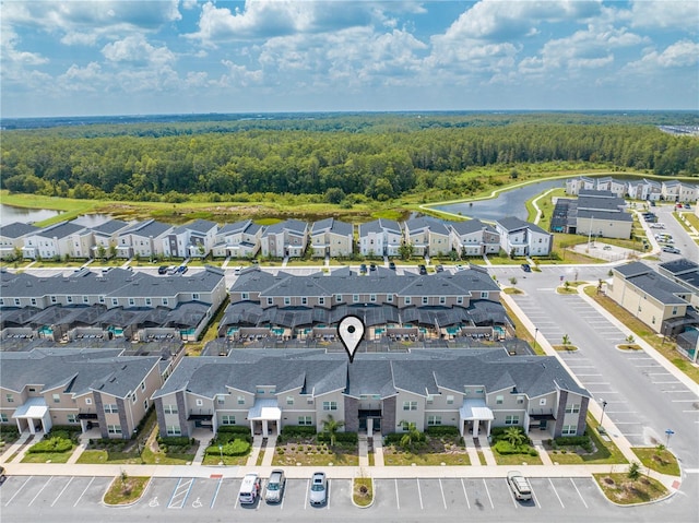 birds eye view of property with a residential view and a view of trees