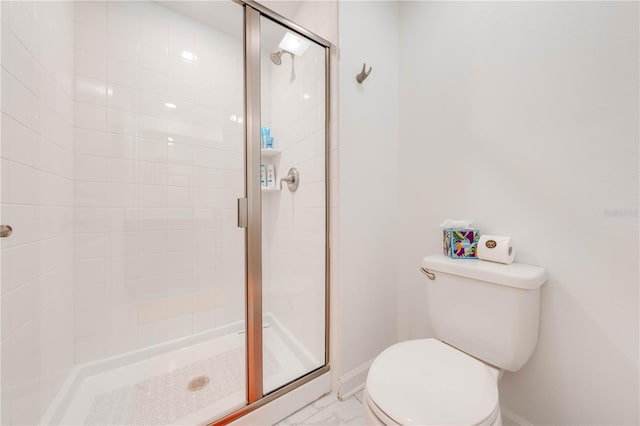 full bathroom with toilet, marble finish floor, a shower stall, and baseboards