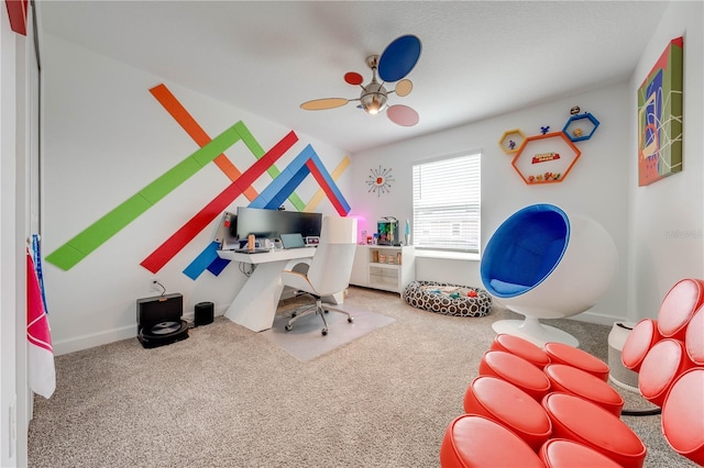 carpeted office space with ceiling fan