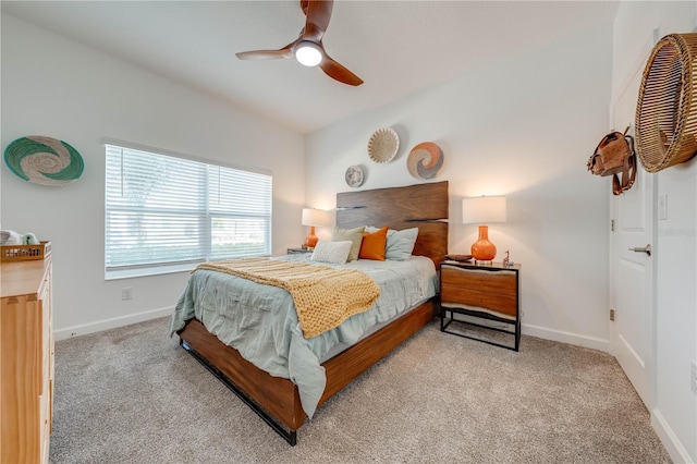 bedroom featuring light colored carpet, ceiling fan, and baseboards