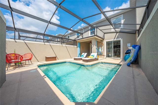 outdoor pool with a patio area and glass enclosure