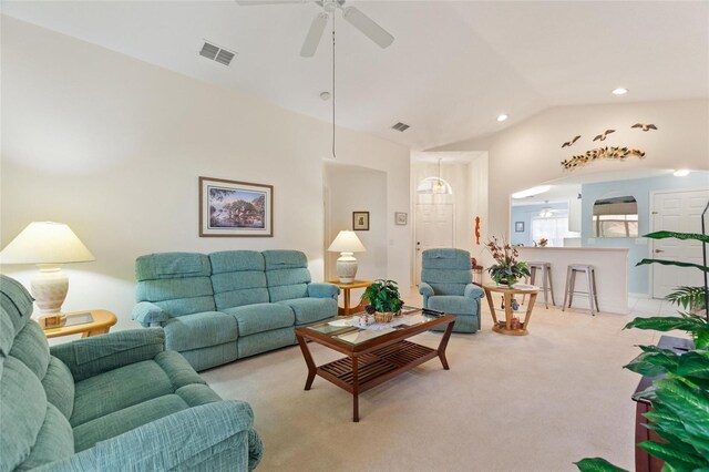 carpeted living room featuring ceiling fan and vaulted ceiling