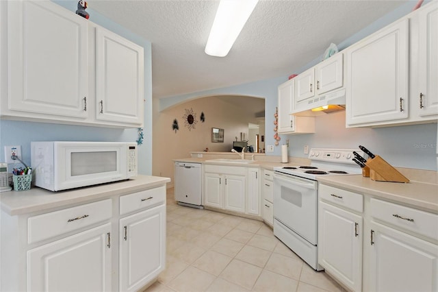 kitchen featuring white appliances, light countertops, under cabinet range hood, and white cabinetry