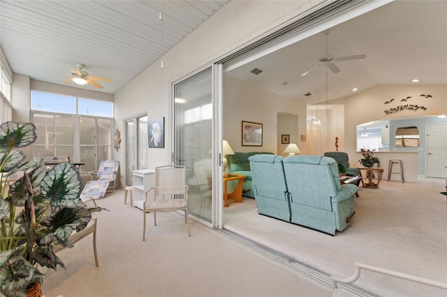 carpeted living room featuring ceiling fan and lofted ceiling