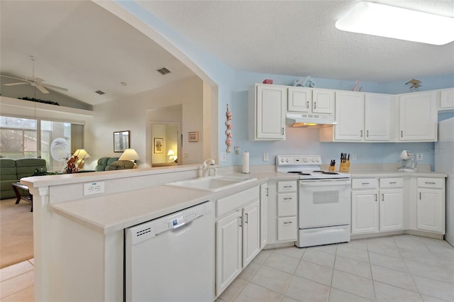 kitchen featuring white cabinetry, white appliances, vaulted ceiling, light tile patterned floors, and kitchen peninsula