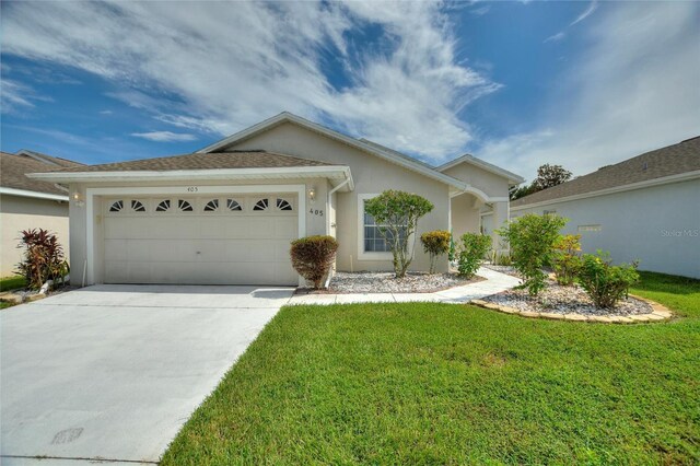 ranch-style home featuring a front lawn and a garage