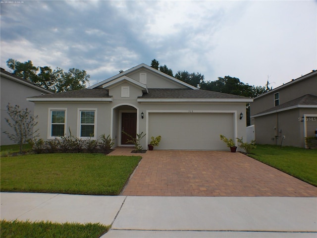 view of front of house with a garage and a front lawn