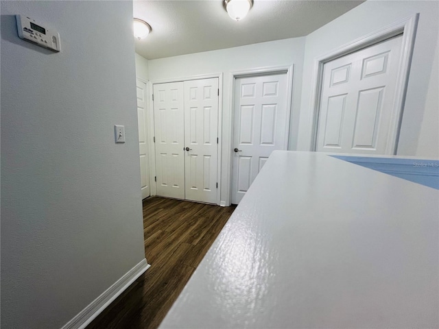 hallway featuring dark hardwood / wood-style floors