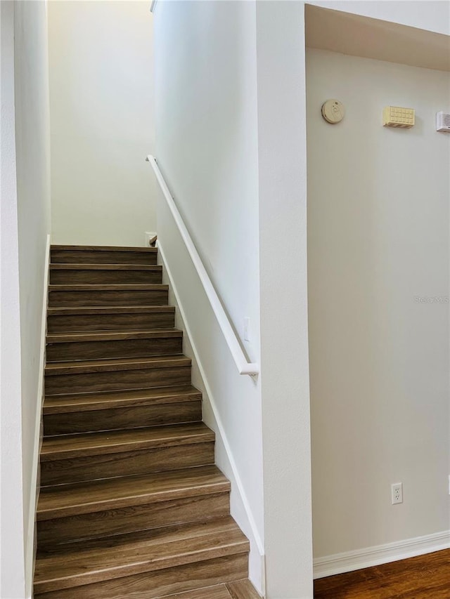 staircase with hardwood / wood-style floors