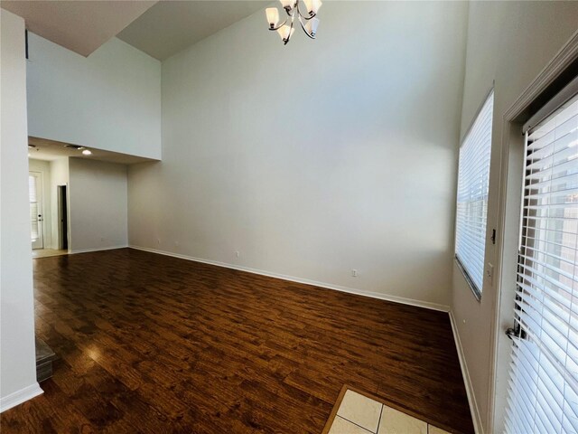 interior space featuring a high ceiling, a chandelier, and hardwood / wood-style flooring