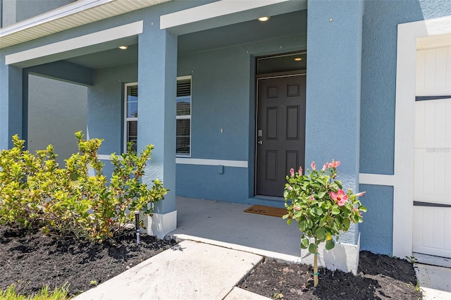 doorway to property featuring covered porch