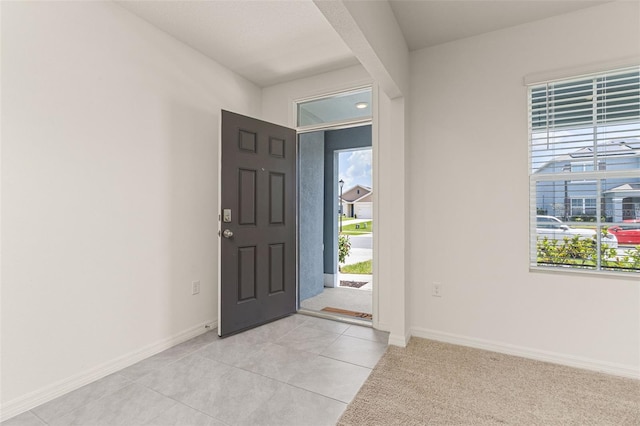 foyer entrance featuring light tile patterned flooring