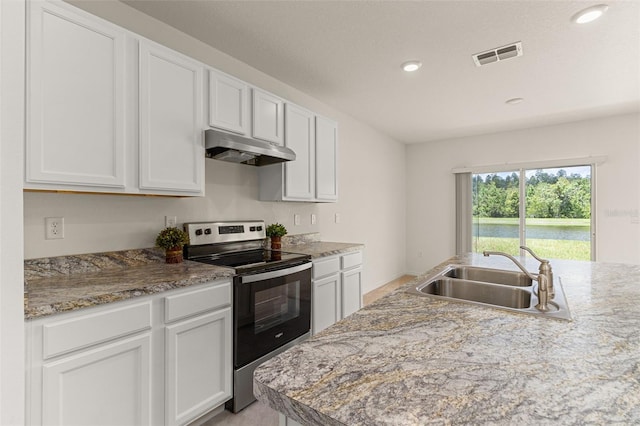 kitchen featuring light stone countertops, white cabinetry, stainless steel electric range oven, and sink