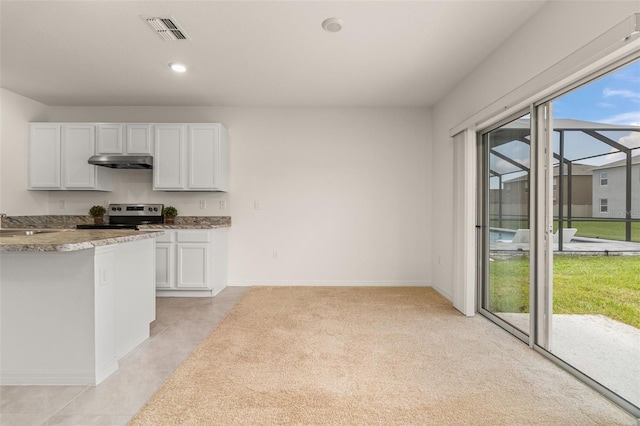 kitchen featuring white cabinets, light tile patterned flooring, stainless steel electric range oven, and sink