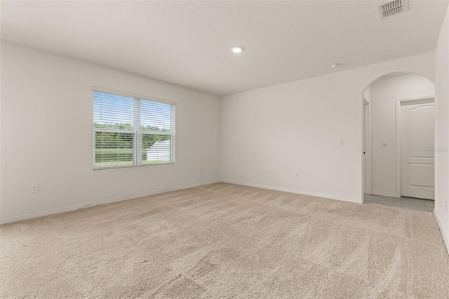 empty room with light colored carpet