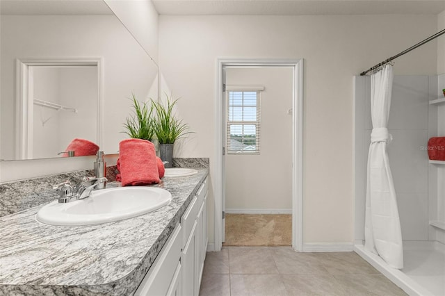 bathroom featuring curtained shower, tile patterned flooring, and vanity