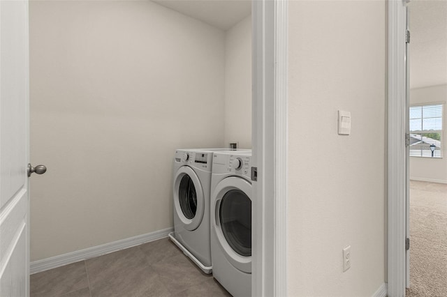 washroom featuring light tile patterned flooring and washer and dryer