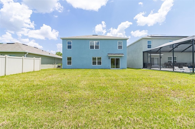 rear view of property with a patio area, a yard, a lanai, and cooling unit