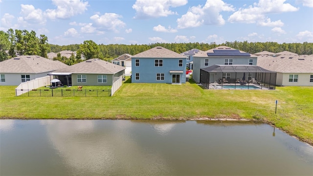 rear view of property featuring a lawn, a lanai, and a water view