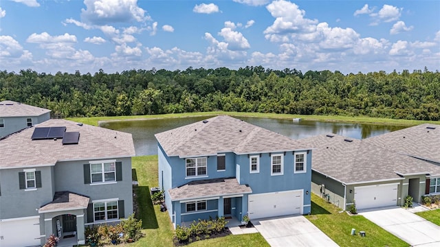 view of front facade with a water view and a front lawn