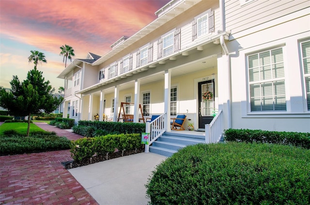 exterior entry at dusk with a porch