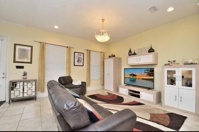 tiled living room with an inviting chandelier