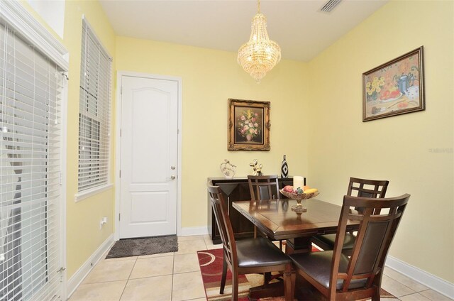 dining area with an inviting chandelier and light tile patterned flooring