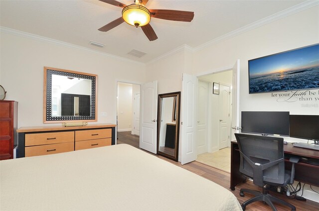 bedroom featuring light hardwood / wood-style flooring, ornamental molding, and ceiling fan