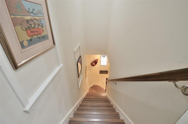 stairway with hardwood / wood-style floors