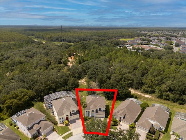 drone / aerial view with a residential view and a wooded view