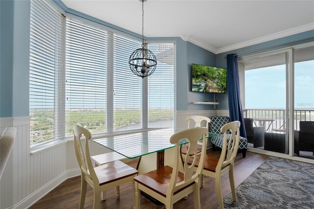 dining room with a notable chandelier, crown molding, and wood-type flooring