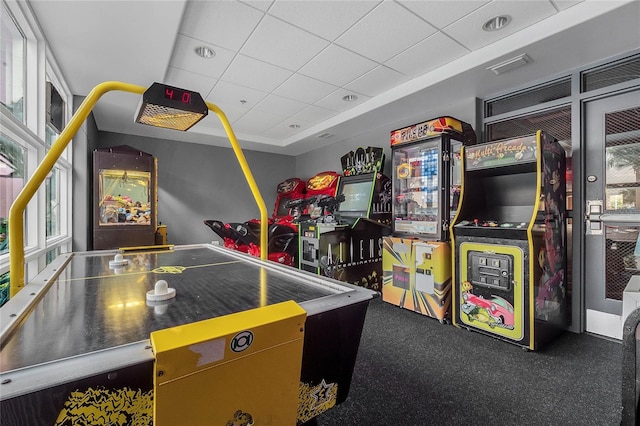 game room featuring a drop ceiling and a healthy amount of sunlight