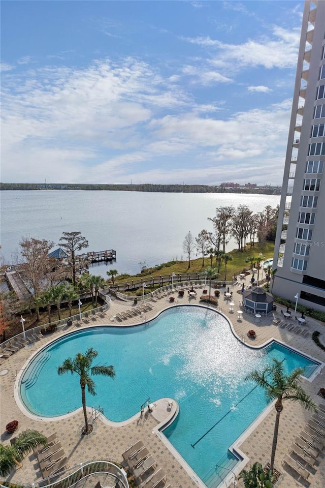 view of pool featuring a patio and a water view