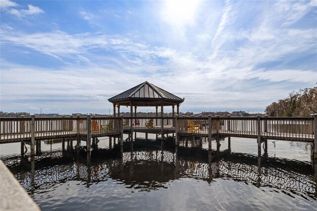 view of dock with a gazebo and a water view