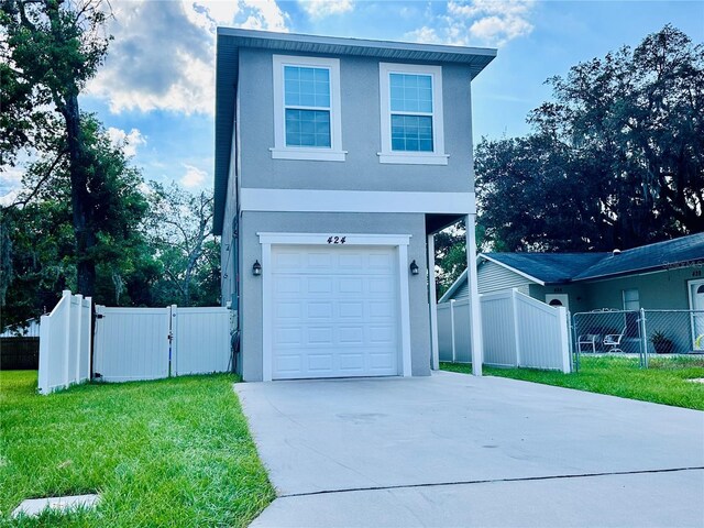 view of front of property with a garage and a front lawn